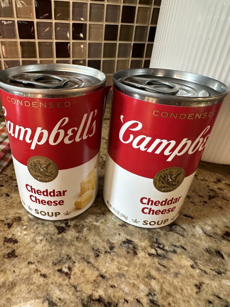 Two cans of Campbell's Cheddar Cheese soup