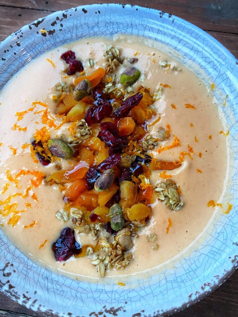 Dried fruits and seeds sprinkled over an Orange Immunity Bowl
