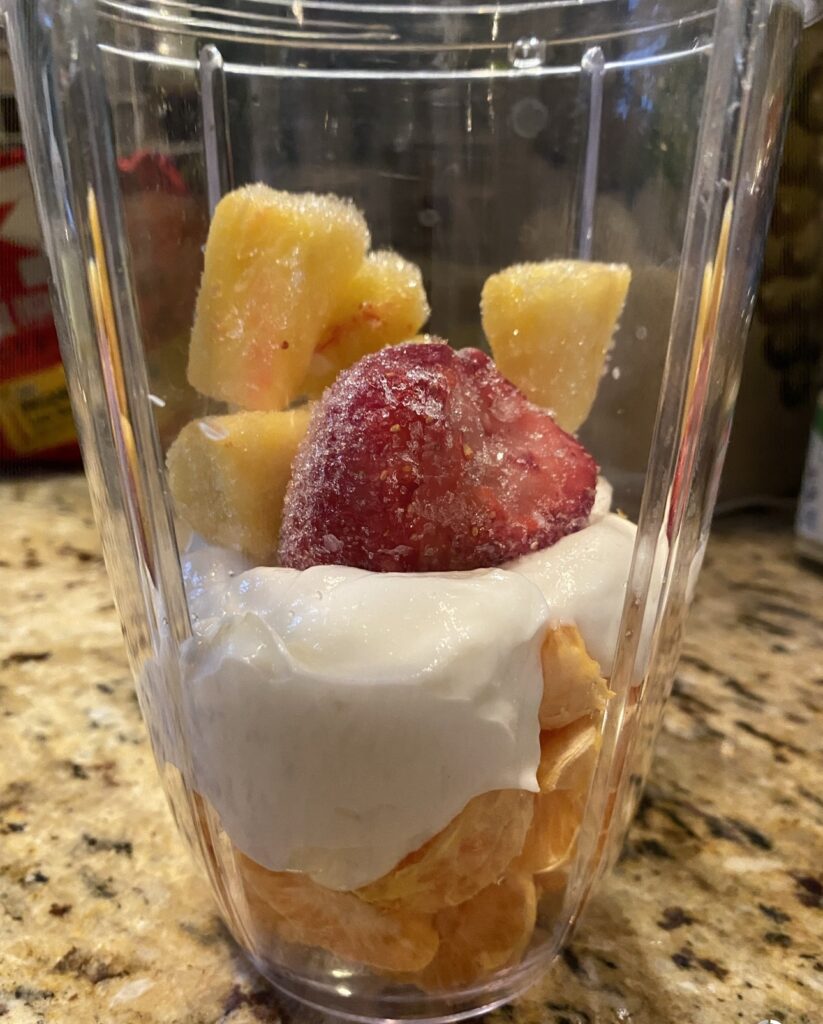 Frozen fruit and Greek yogurt in a blender