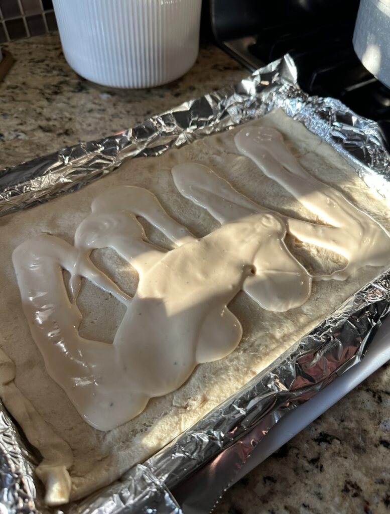 Alfredo sauce over pastry dough