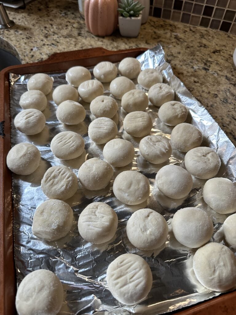 Frozen rolls placed across a baking sheet