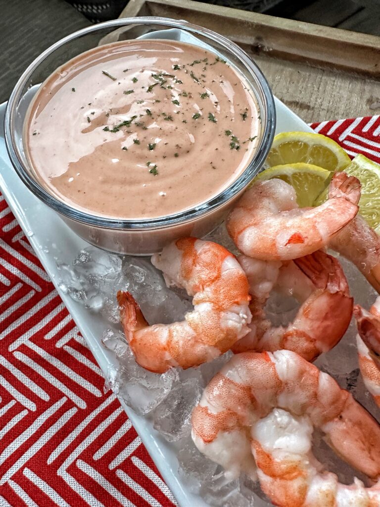 Shrimp over ice with lemon and sauce
