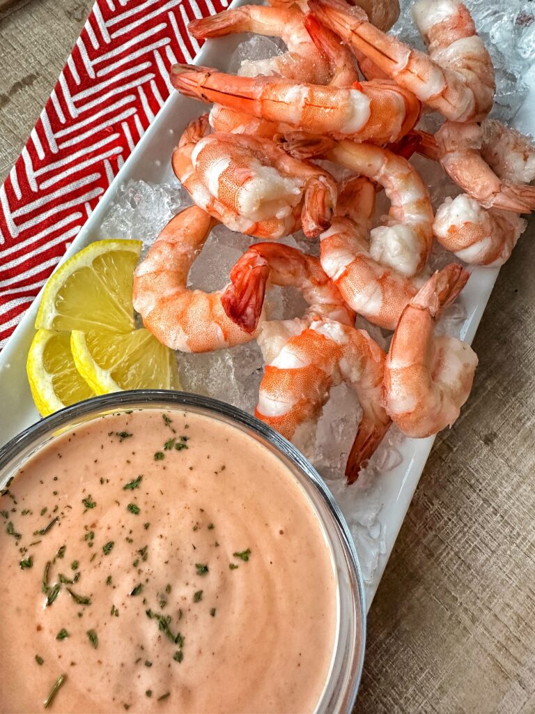 Shrimp over ice next to sauce