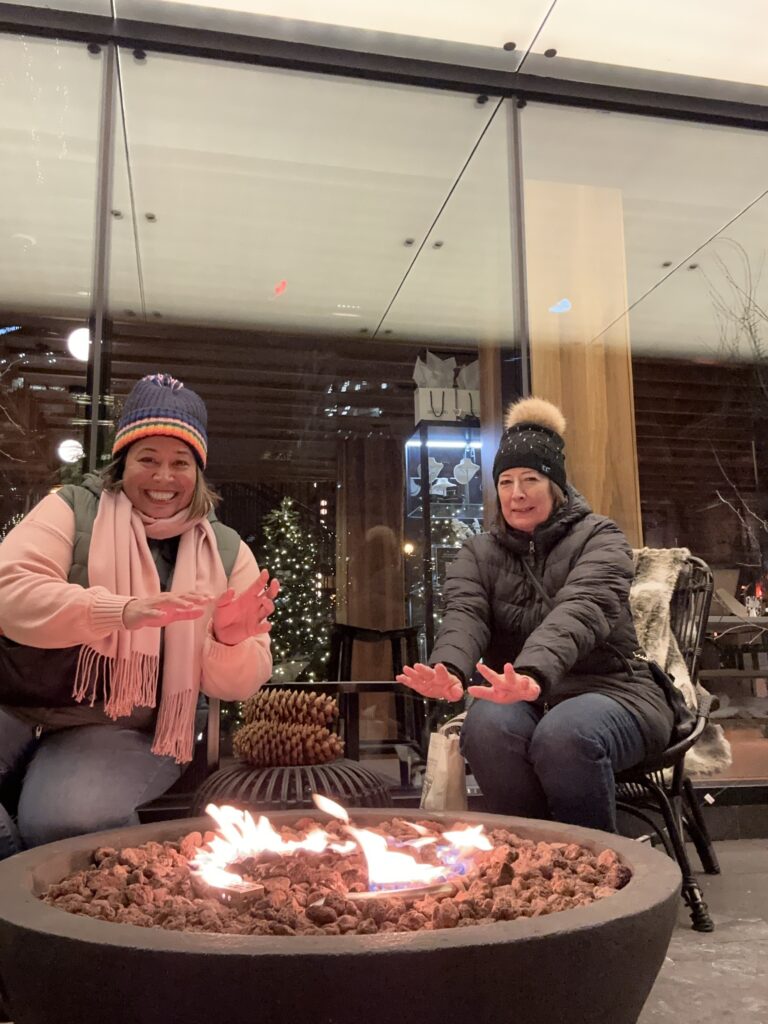 Mom and me warming our hands by a fire