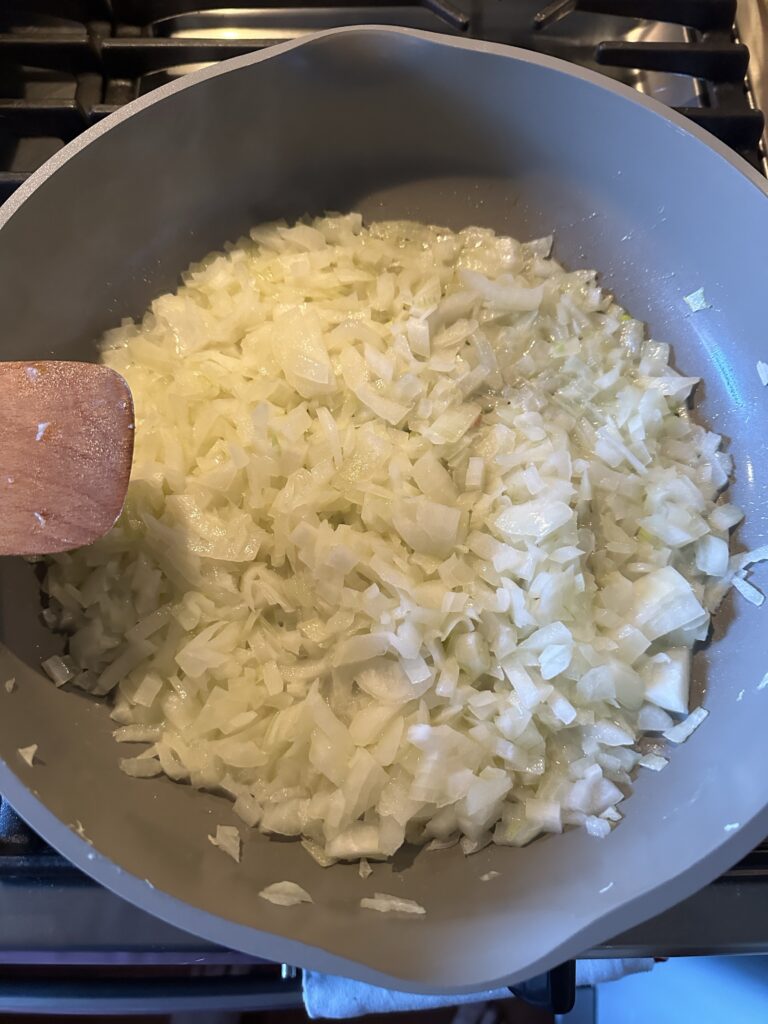 Raw onions beginning to cook in a pan
