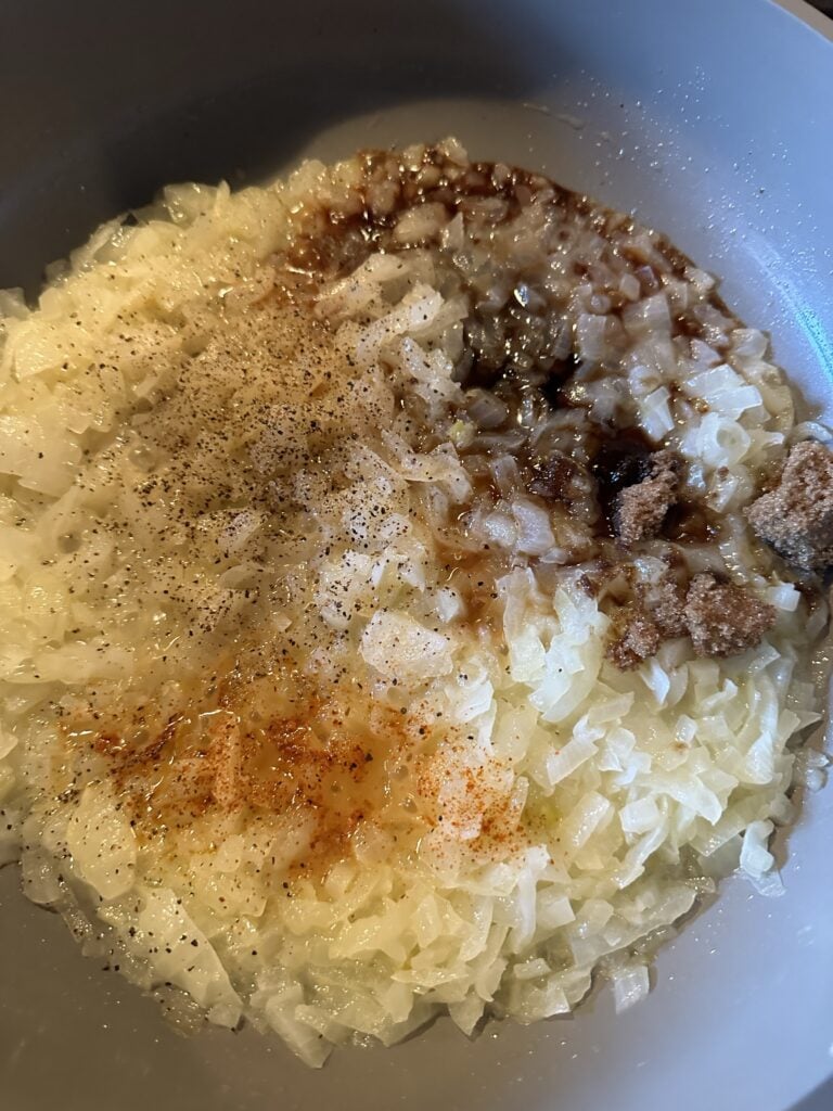The onion and seasonings cooking together in the pan