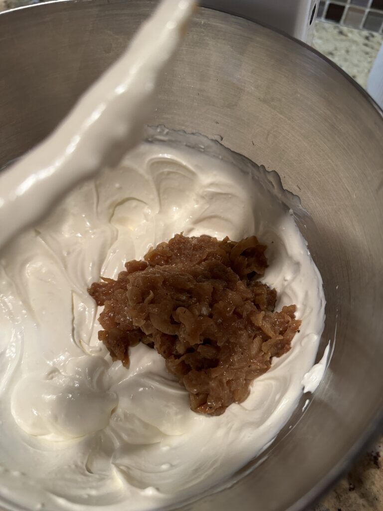 The onion being mixed in with the rest of the dip