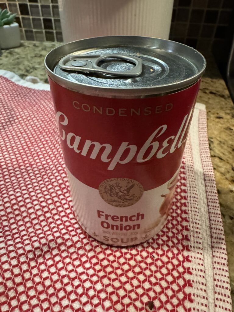 A can of Campbell's French Onion Soup on a red and white patterned cloth