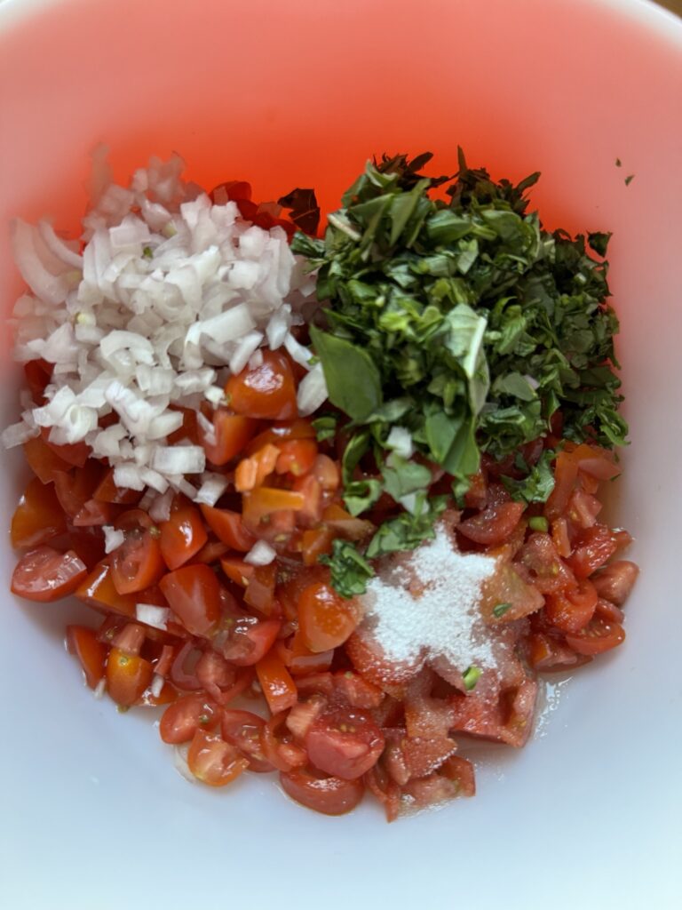 Tomato, onions, and basil macerating in sugar