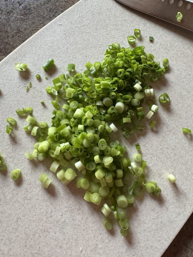 Sliced green onion on a cutting board