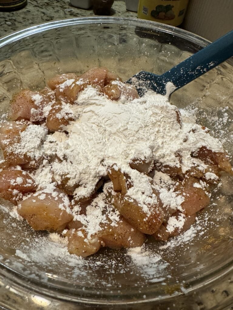 Raw, seasoned chicken covered in corn starch