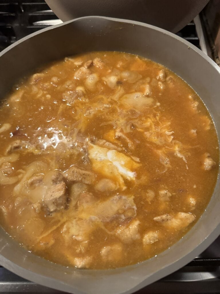 Chicken cooking in sauce