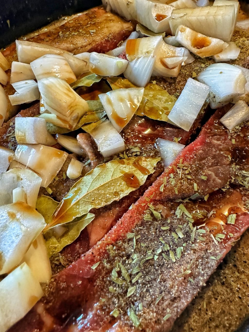 The raw country ribs covered in sauces and seasonings