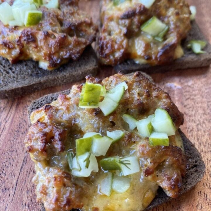 mini rye bread slices with ground pork sausage crumbled on top, velveeta cheese melted in with onions and pickles