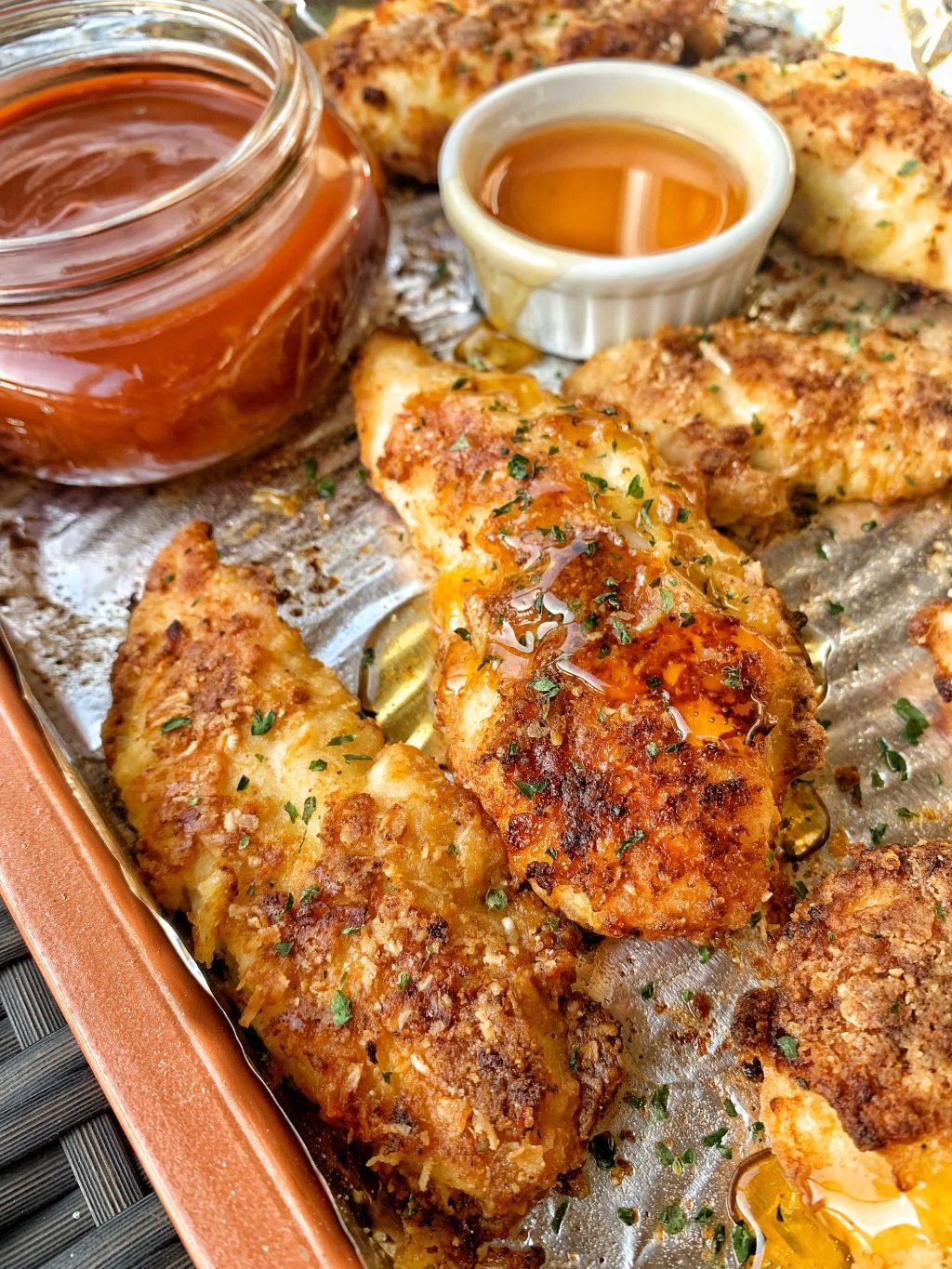 Oven baked parmesan chicken tenders drizzled with honey