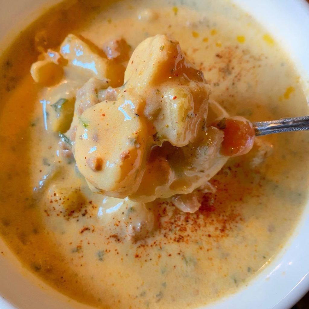 A spoonful of Cheeseburger Soup with mini potato dumplings