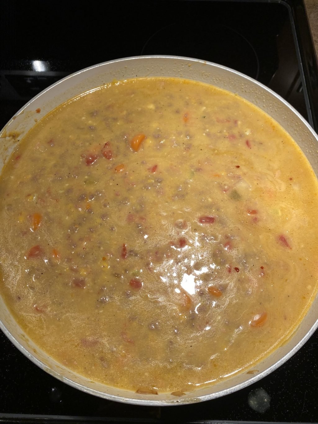 The Cheeseburger Soup cooking in a pot on the stovetop