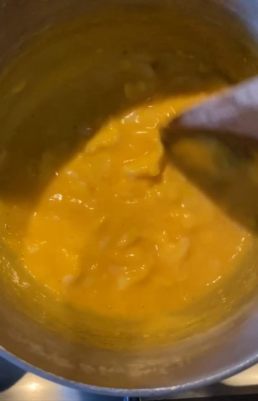 Eggs cooking in a pot, partially solidifying