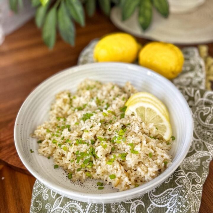 a beige bowl with white rice that has been crisped up with fresh lemons and garlic and black pepper.