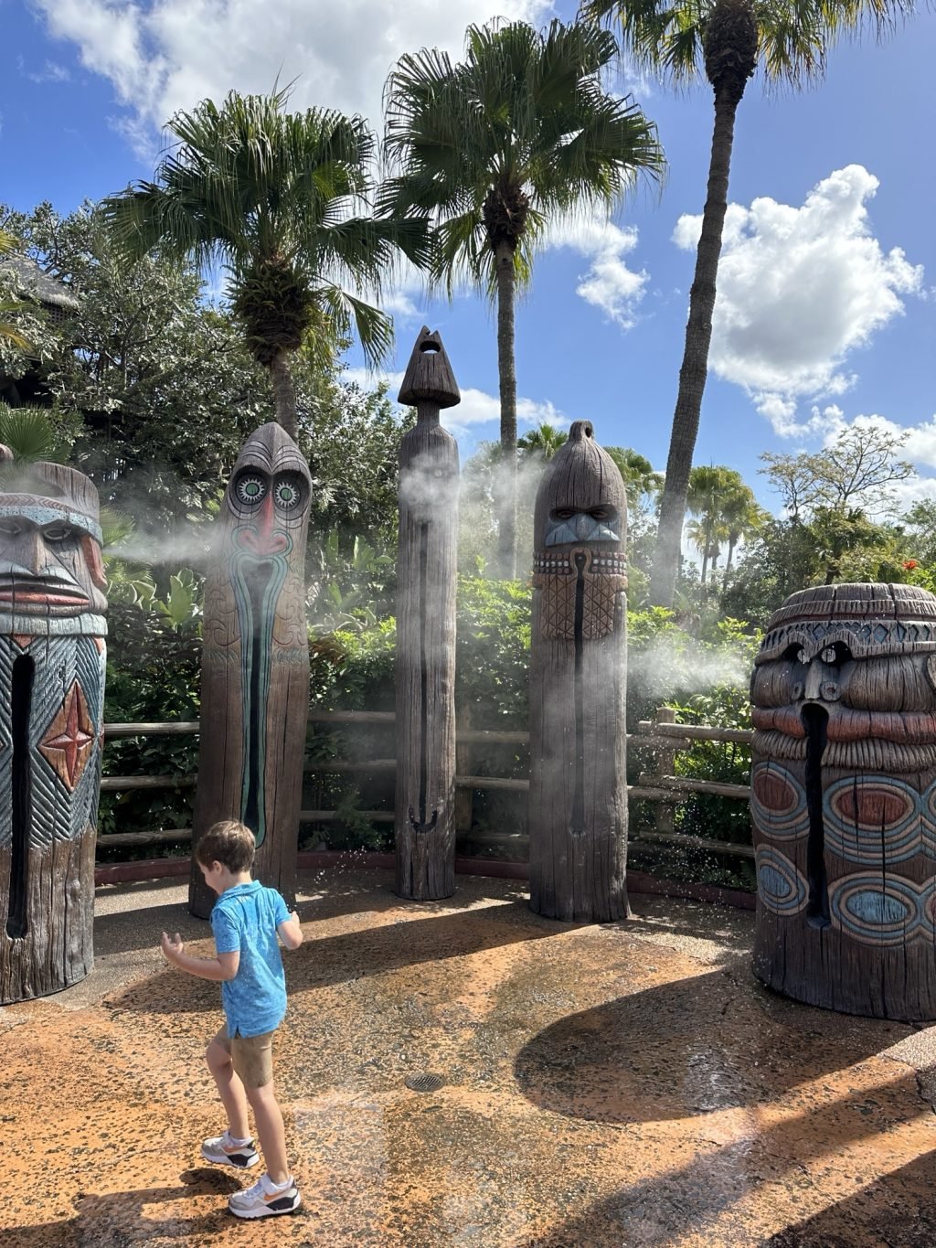 Tiki statures spraying mist