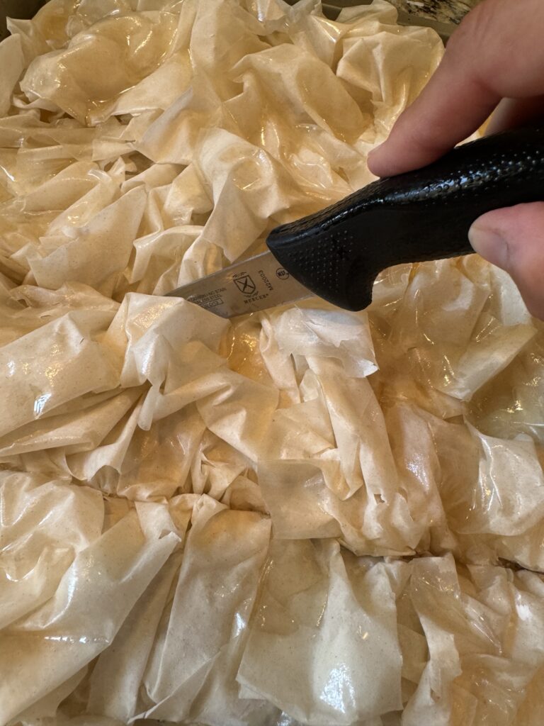 A knife slicing into the prebaked cheeseburger squares