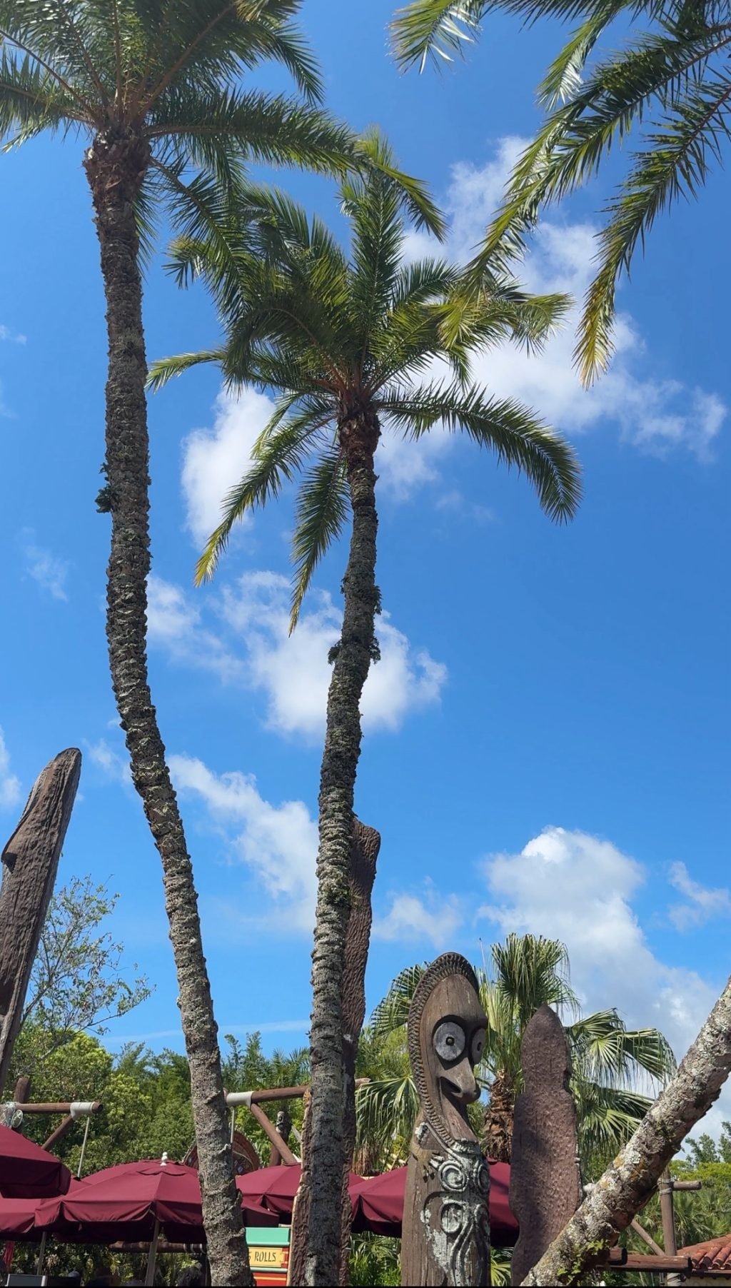 Palm trees with a Tiki statue at the base