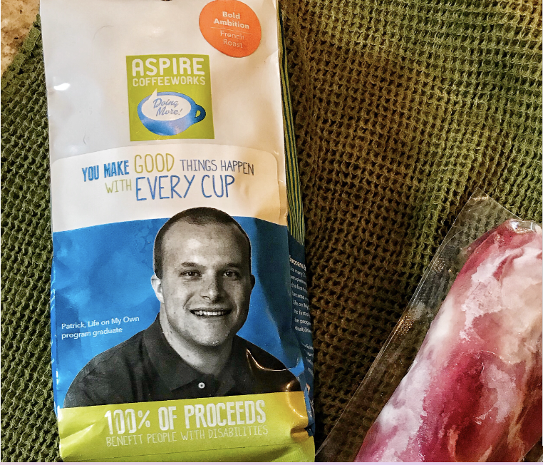 A package of Aspire Coffee next to a packaged raw pork tenderloin.