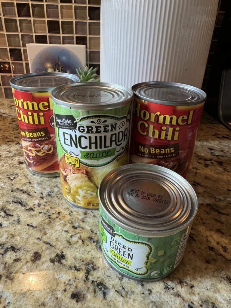 Cans of enchilada sauce, chili, and diced green chiles. 