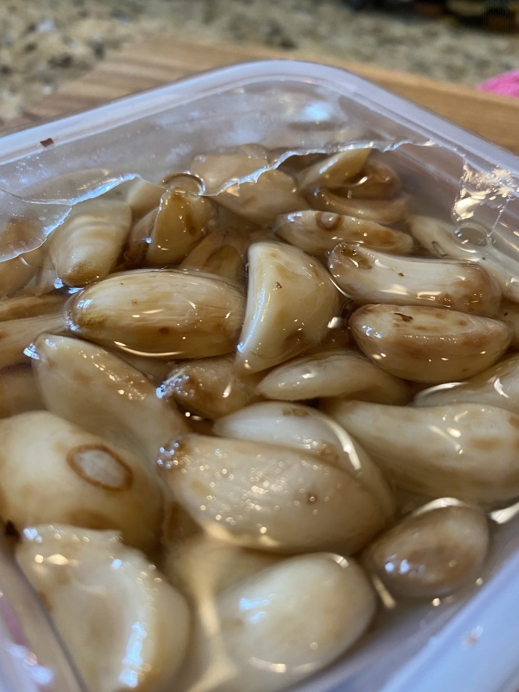 A close up of marinated garlic.