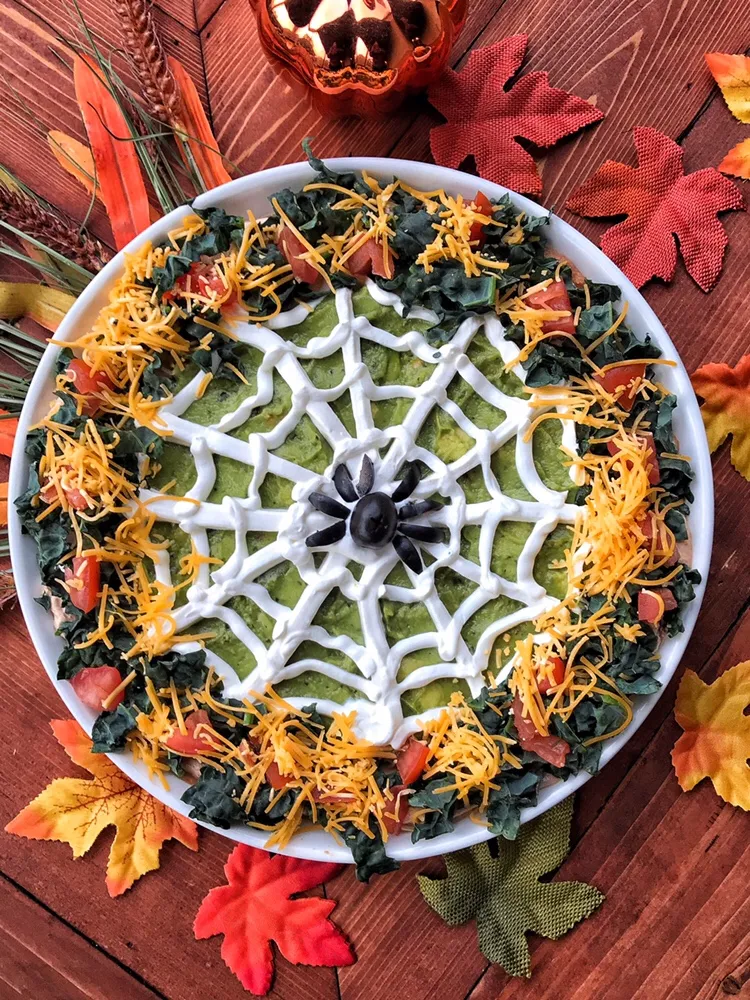 Halloween dip with a sour cream spider web on top.