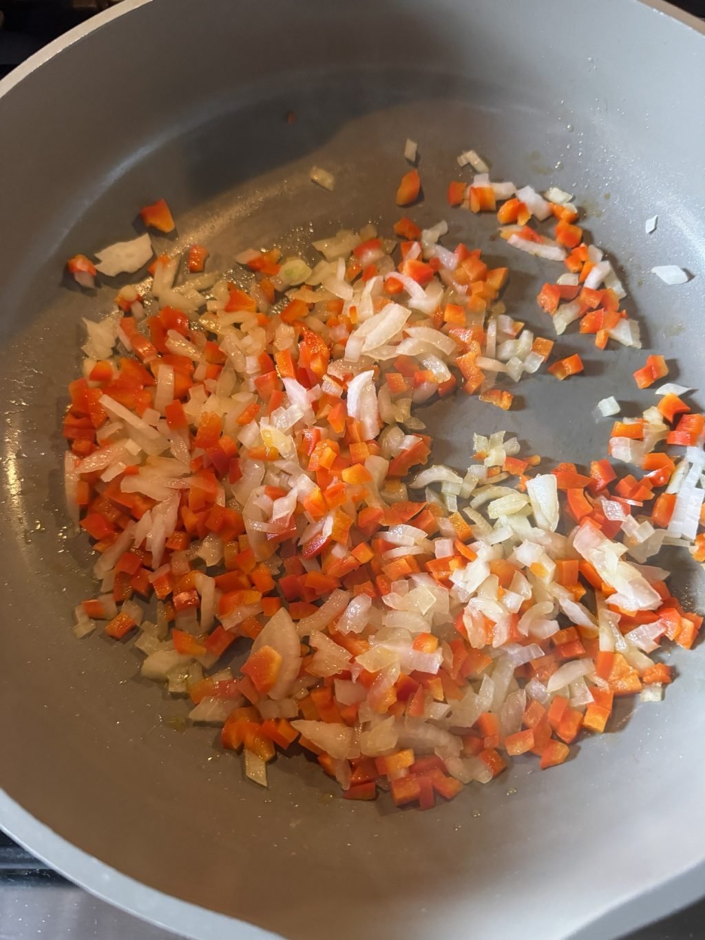 Diced peppers and onions in the pan.