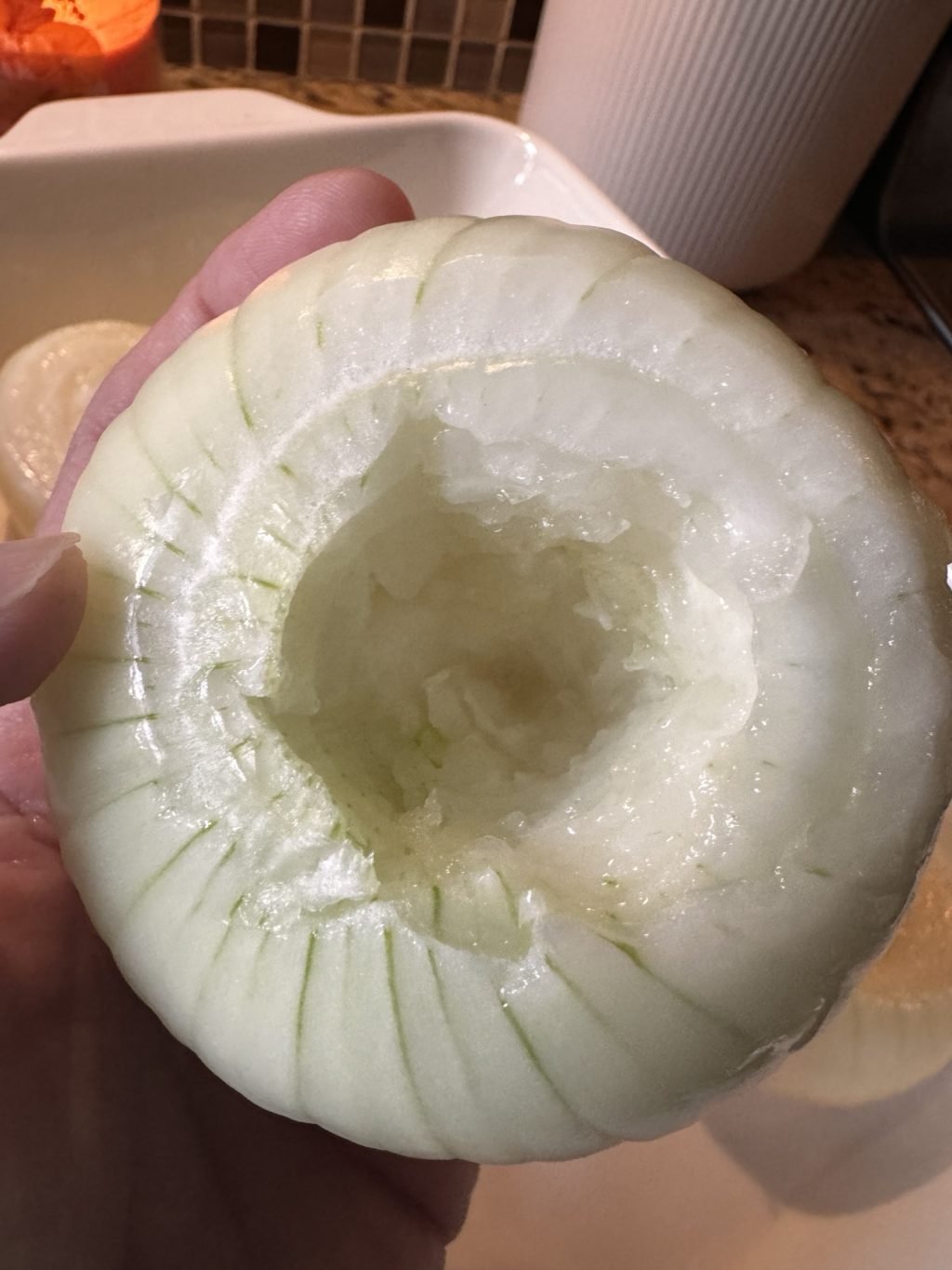 A white onion with the center hollowed out.