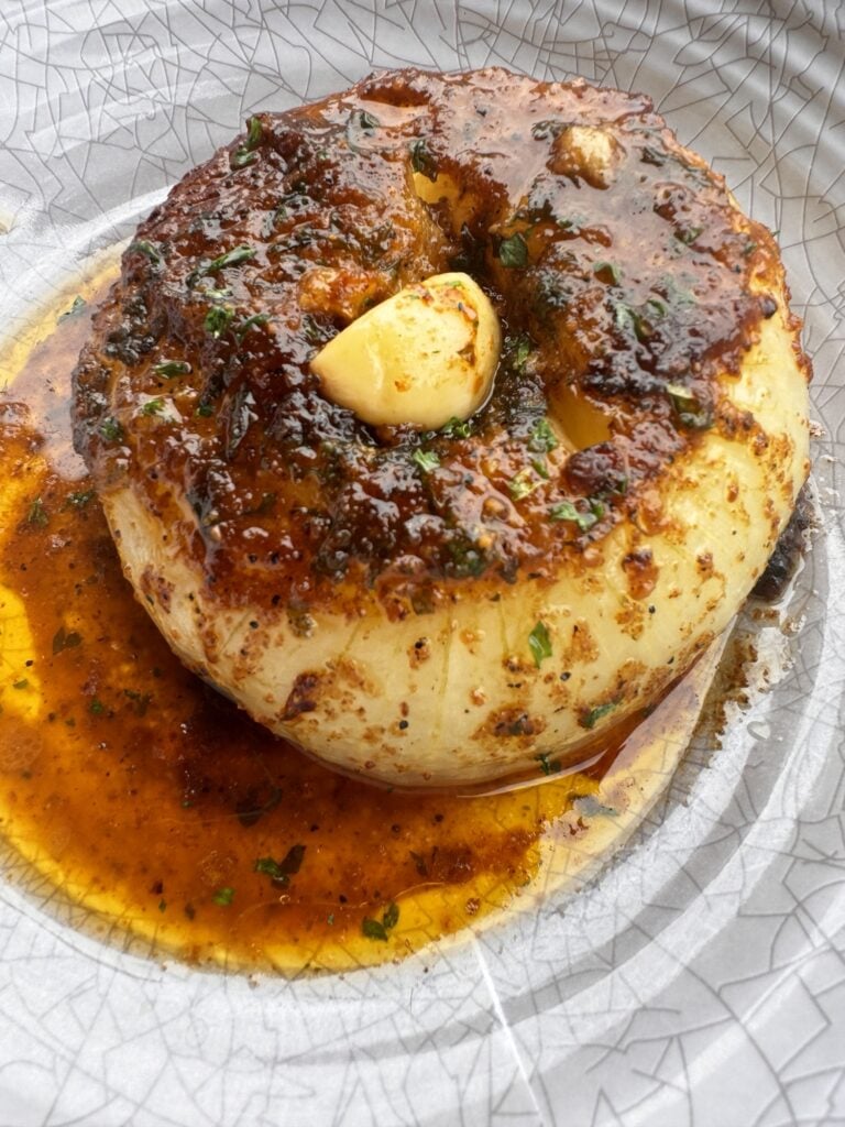 The finished baked onion in a bowl.