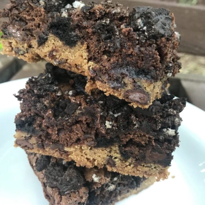 Three, three layer brownies stacked on top of each other.