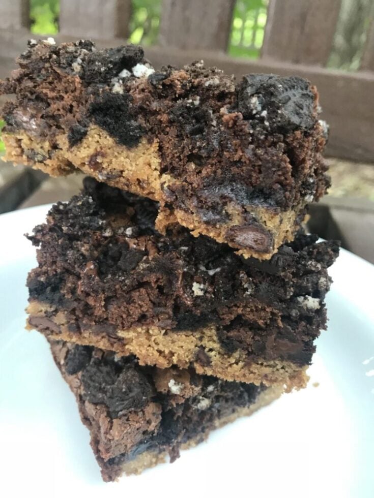 Three, three layer brownies stacked on top of each other.