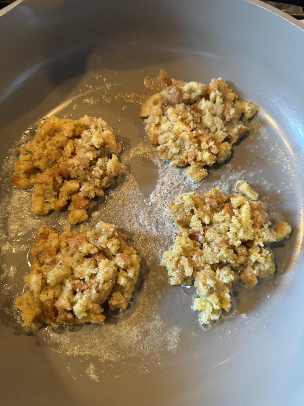 Stuffing patties cooking in a pan.