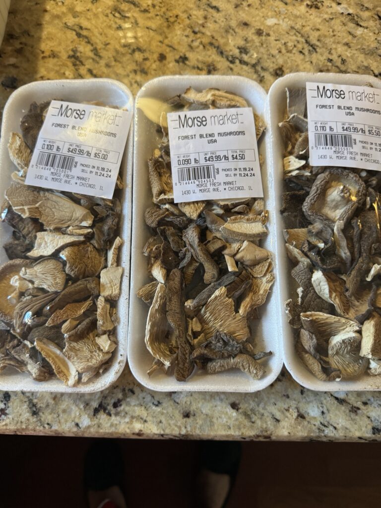 Three packages of forest blend mushrooms.