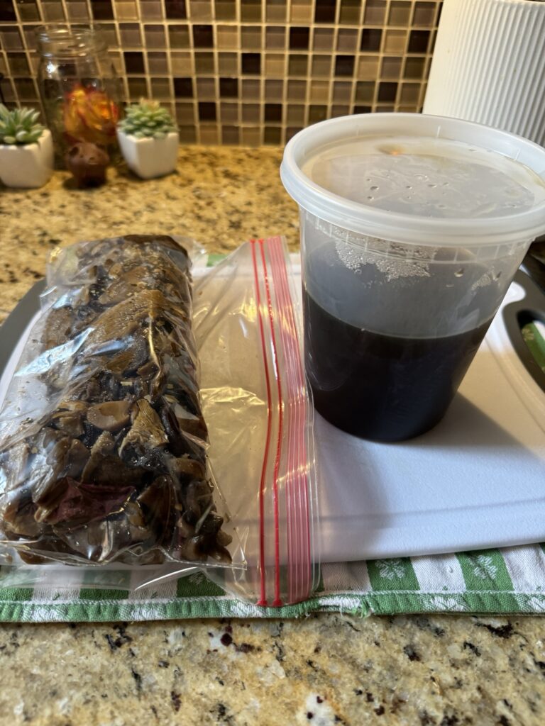 Sliced mushrooms in a Ziploc bag next to a plastic container of dark liquid.