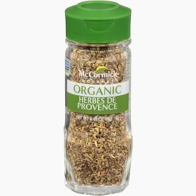 A small glass bottle of McCormick Herbes De Provence.