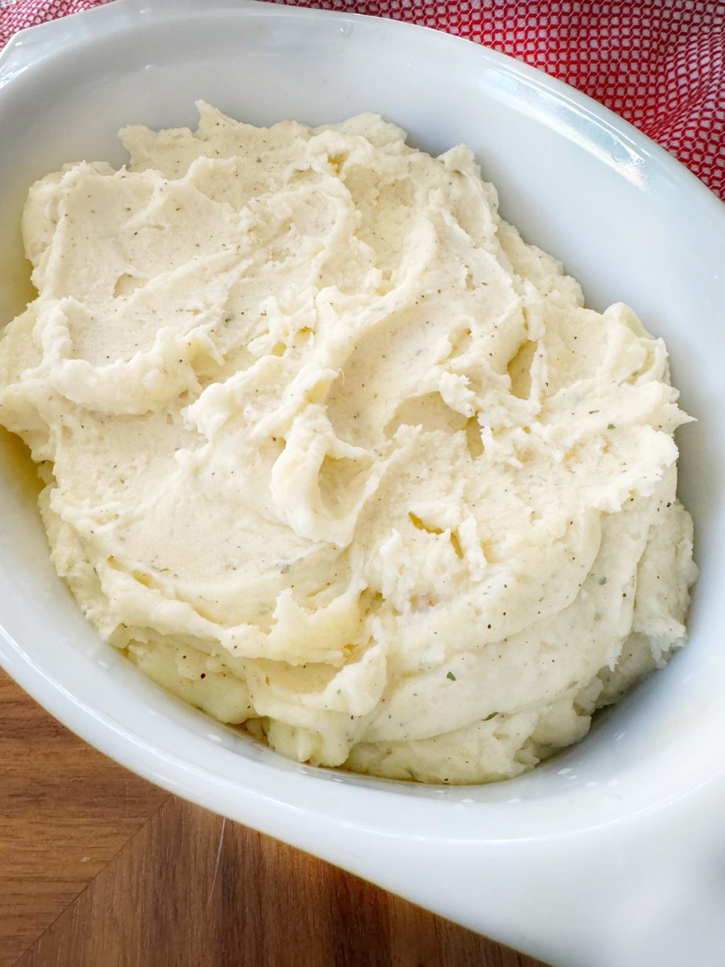 Mashed potatoes in a white dish.