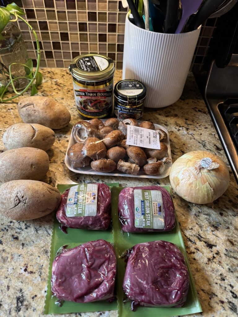 The ingredients for the dish, including potatoes, onions, mushrooms, and sirloin medallions