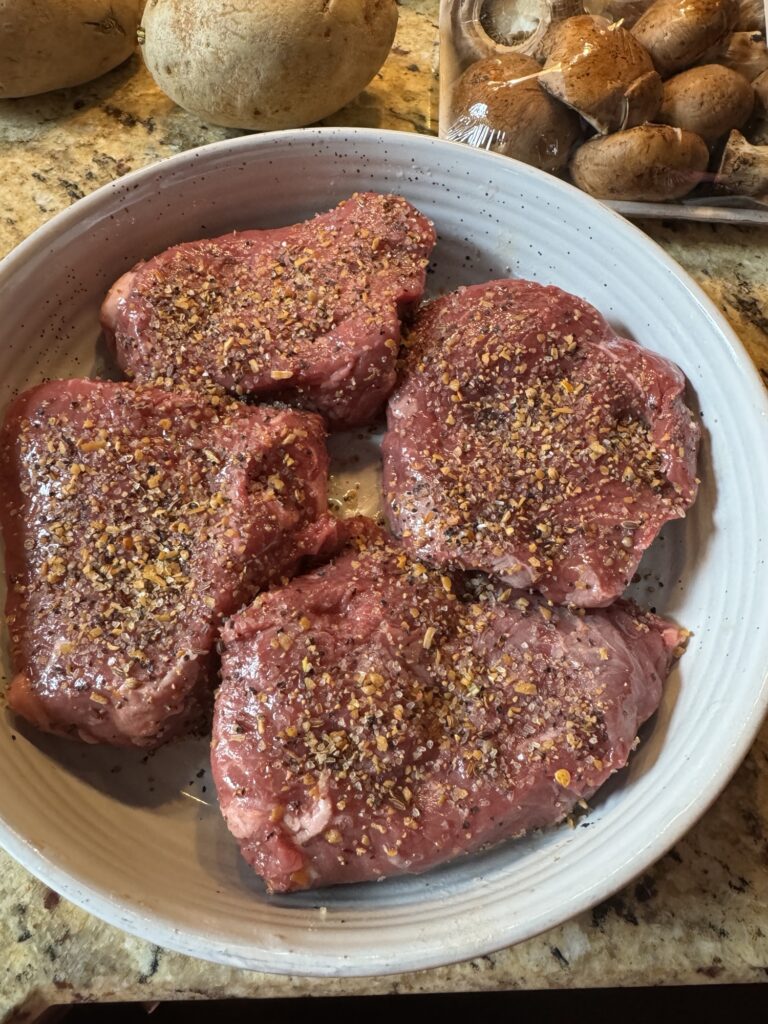 Raw, seasoned sirloin medallions