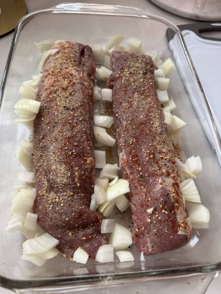 Seasoned raw tenderloins with onions