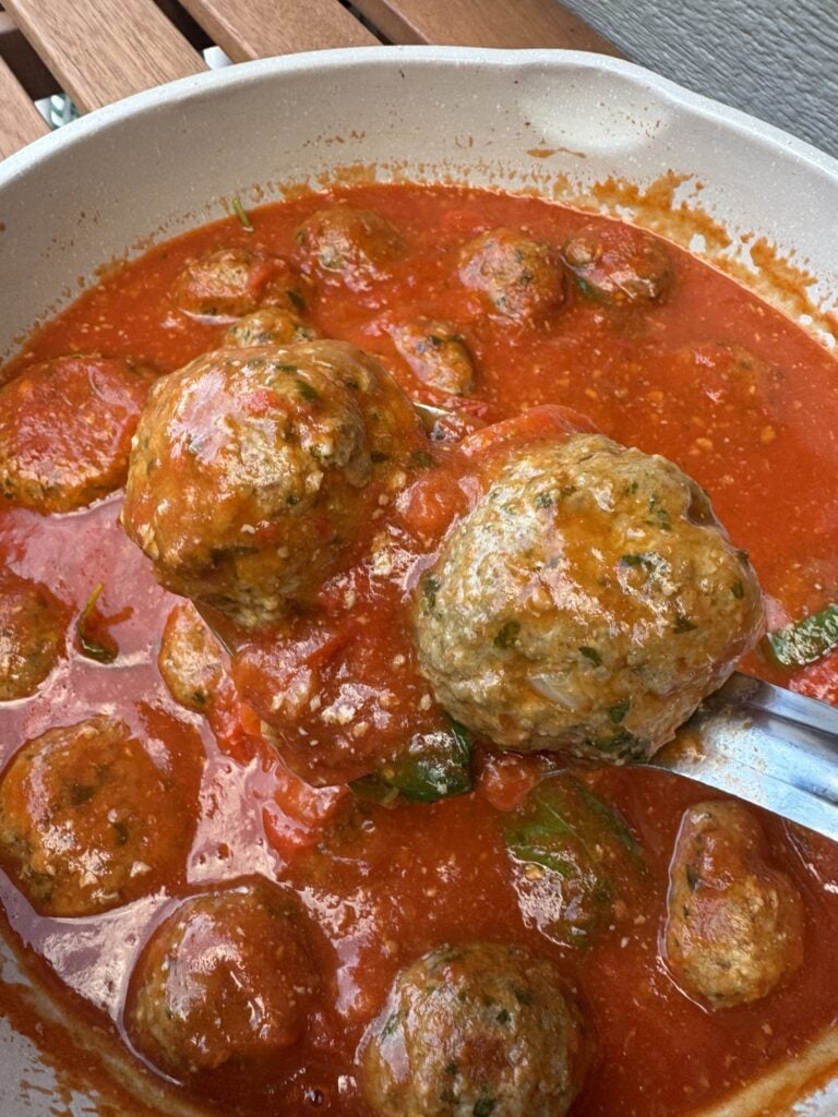 Two meatballs on a spoon