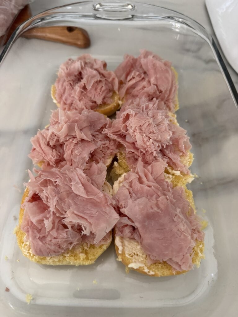 Deli meats on a slab of the bottom half of rollls