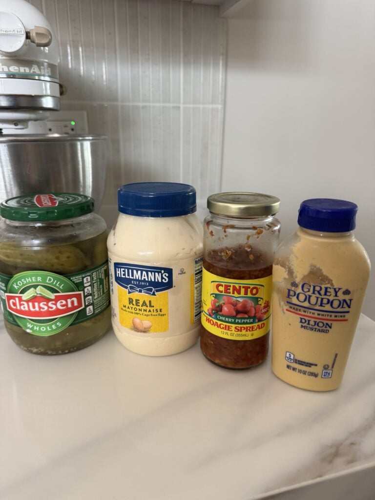 Pickles, mayonnaise, cherry pepper hoagie spread, and mustard