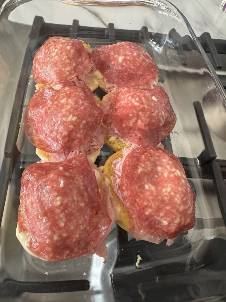 Salami on top of shaved ham on rolls