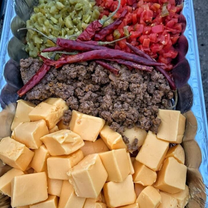 Cubed cheese, ground meat, chili peppers, and diced tomatoes