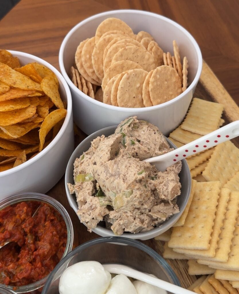 A grazing board with the dip and various crackers and chips