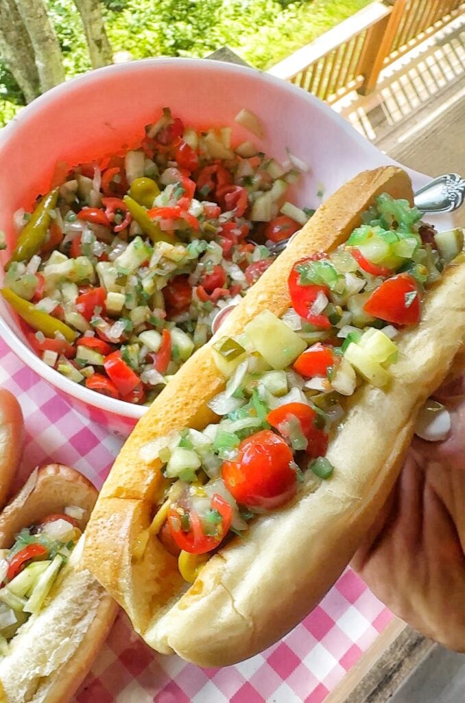 A hot dog topped with the Chicago hot dog topper